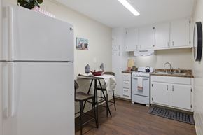 Tuscaloosa apartment for rent - A kitchen with white cabinets and a white refrigerator.