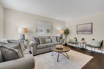 Tuscaloosa apartment for rent - A living room with a grey couch, a coffee table, and a painting on the wall.