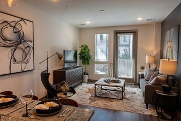 Madison apartment for rent - A modern living room with a dining table set for two.