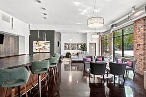 Tuscaloosa apartment for rent - A modern dining room with a long table and chairs.