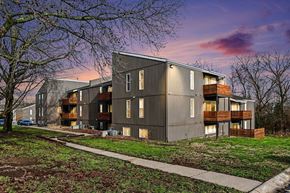 Warrensburg apartment for rent - A modern apartment building with a grassy area in front.