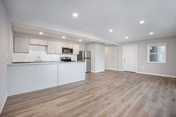 Kansas City apartment for rent - A kitchen with white cabinets and a wooden floor.