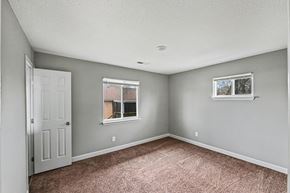 Raytown apartment for rent - A room with a carpeted floor and a window.
