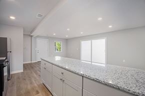 Kansas City apartment for rent - A kitchen with granite countertops and white cabinets.at Palisades Apartments, Kansas City, 64133