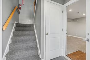 Raytown apartment for rent - A hallway with a staircase and a door.