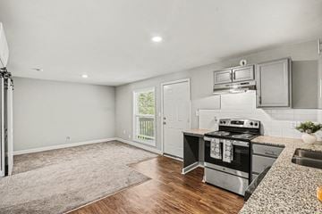 Independence apartment for rent - A kitchen with a stove top oven and a sink.
