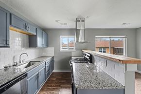 Raytown apartment for rent - A kitchen with a granite countertop and stainless steel appliances.