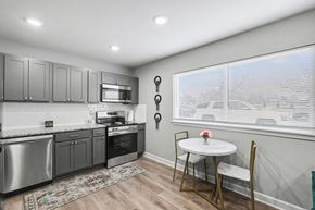 Kansas City apartment for rent - A kitchen with a table and chairs by the window at Mayfair Apartments, Apartments, Kansas City, MO