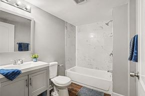 Independence apartment for rent - A white bathroom with a toilet, sink, and bathtub.