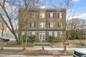 Newport News apartment for rent - A red brick building with a white door and windows. at Shipyard Shores Apartments, Newport News, VA, 23607