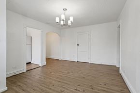 Newport News apartment for rent - A room with a chandelier and wooden floors. at Shipyard Shores Apartments, Newport News, Virginia