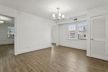 A room with wooden floors and white walls.