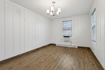 A room with wooden floors and white walls.