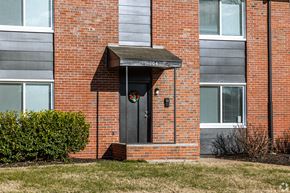 Kansas City apartment for rent - A red brick building with a black door and a small porch. at Blacklark Apartments, Apartments, Kansas City, KS