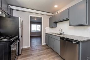 Kansas City apartment for rent - A kitchen with a stove, dishwasher, and cabinets. at Blacklark Apartments, Kansas