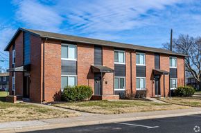 Kansas City apartment for rent - A red brick apartment building with a black roof. at Blacklark Apartments, Kansas City, 66101
