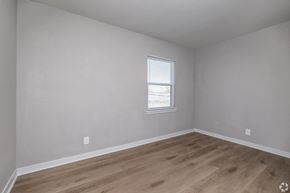 Kansas City apartment for rent - A room with a window and wooden flooring. at Blacklark Apartments, Kansas City, Kansas