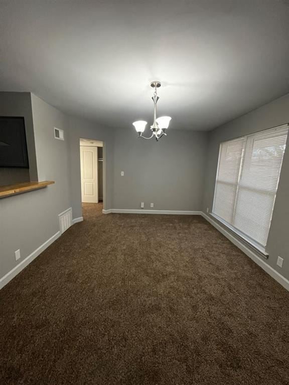 Kansas City townhouse for rent - a empty room with a large window and a chandelier