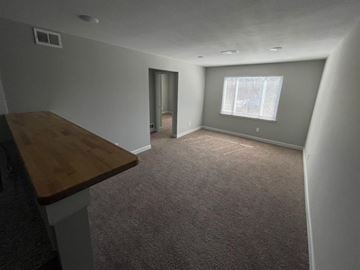 Topeka apartment for rent - a living room with a wooden table and a window