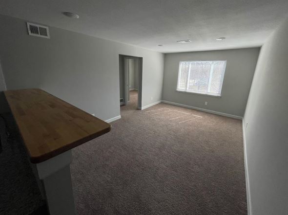 Topeka apartment for rent - a living room with a wooden mantle and a window