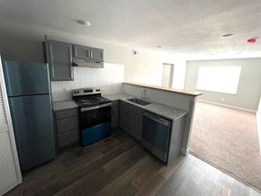 Topeka apartment for rent - an empty kitchen with a stove and a refrigerator