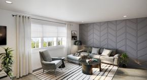 Talahassee apartment for rent - A modern living room with a grey sofa, a grey armchair, a coffee table, and a plant.
