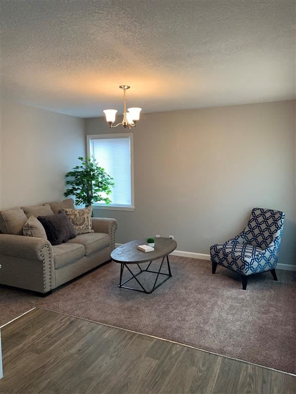 Belton triplex for rent - a living room with a couch, a chair and a table