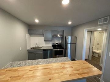 Grandview apartment for rent - a kitchen with a wooden table and a refrigerator