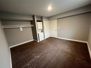 Raytown apartment for rent - a bedroom with an open closet and washer and dryer