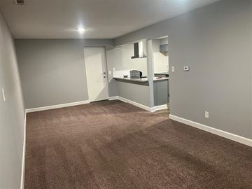 Raytown apartment for rent - a living room with a carpet and a kitchen
