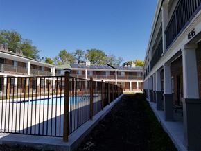 Raytown apartment for rent - a view of a pool in a building with a fence