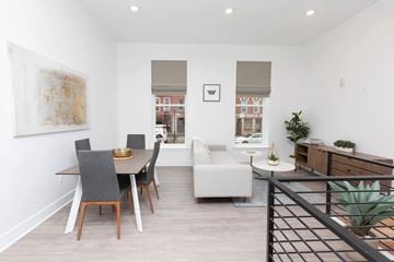 Baltimore apartment for rent - A modern living room with a dining table and chairs.