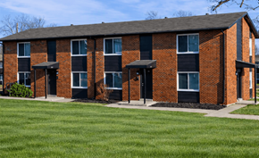 Kansas City apartment for rent - A red brick building with a black roof and windows.
