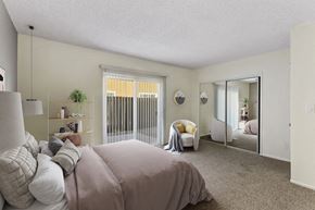 Santa Ana apartment for rent - a bedroom with a large bed and a mirror