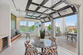 Atlanta apartment for rent - A modern dining room with a glass table and chairs.