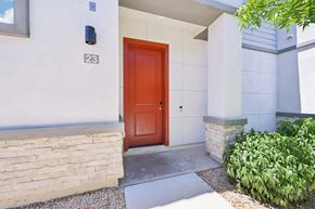 Phoenix apartment for rent - Baseline on 16th townhome red door is the entrance to a house with a stone wall.