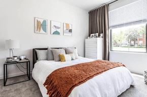 Kansas City apartment for rent - a bedroom with a bed and a large window