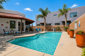 Tucson apartment for rent - A pool with a red roof and a building behind it.