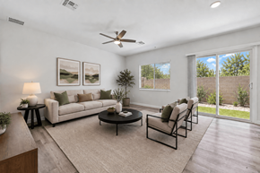Phoenix apartment for rent - A living room with a white couch, a coffee table, and a ceiling fan.