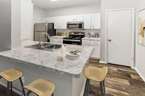 Dallas apartment for rent - a kitchen with a marble counter top and a sink at Heatherstone, Texas