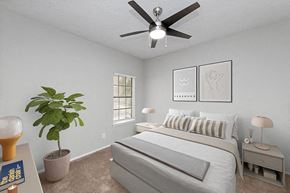 Dallas apartment for rent - a bedroom with a bed and a ceiling fan at Heatherstone, Dallas, TX, 75287