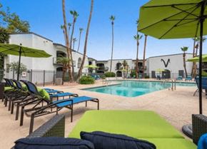 Phoenix apartment for rent - a swimming pool with lounge chairs and umbrellas at Vertu, Phoenix, Arizona