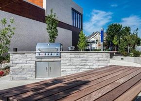 Kansas City apartment for rent - a barbecue grill on a stone wall outside of a building at Marcato, Kansas City, MO