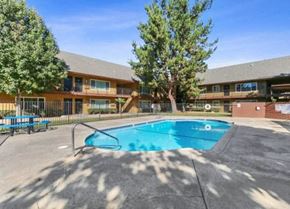 Santa Ana apartment for rent - a swimming pool with a building in the background