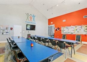 Santa Ana apartment for rent - a conference room with tables and chairs and a television
