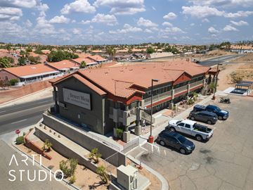 Mesquite apartment for rent - A building with the sign "Desert Mess" is surrounded by parked cars.