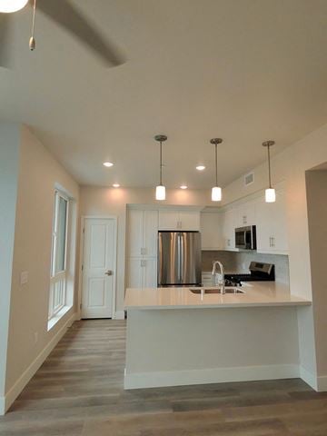 San Diego apartment for rent - A kitchen with a white counter and a stainless steel refrigerator.