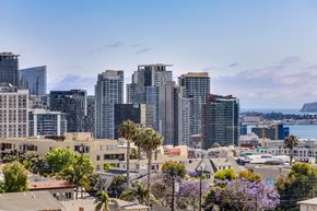 San Diego apartment for rent - the city with tall buildings and palm trees