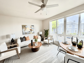 San Diego apartment for rent - A living room with a white couch, a wooden coffee table, and a ceiling fan.