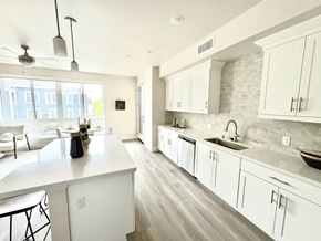 San Diego apartment for rent - A kitchen with white cabinets and a large island.